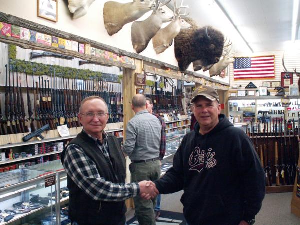 Randy Piearson, President of the Headwaters Chapter, thanks Ed Beall, a manager at Capital Sports in Helena for their on-going support of Pheasants Forever.